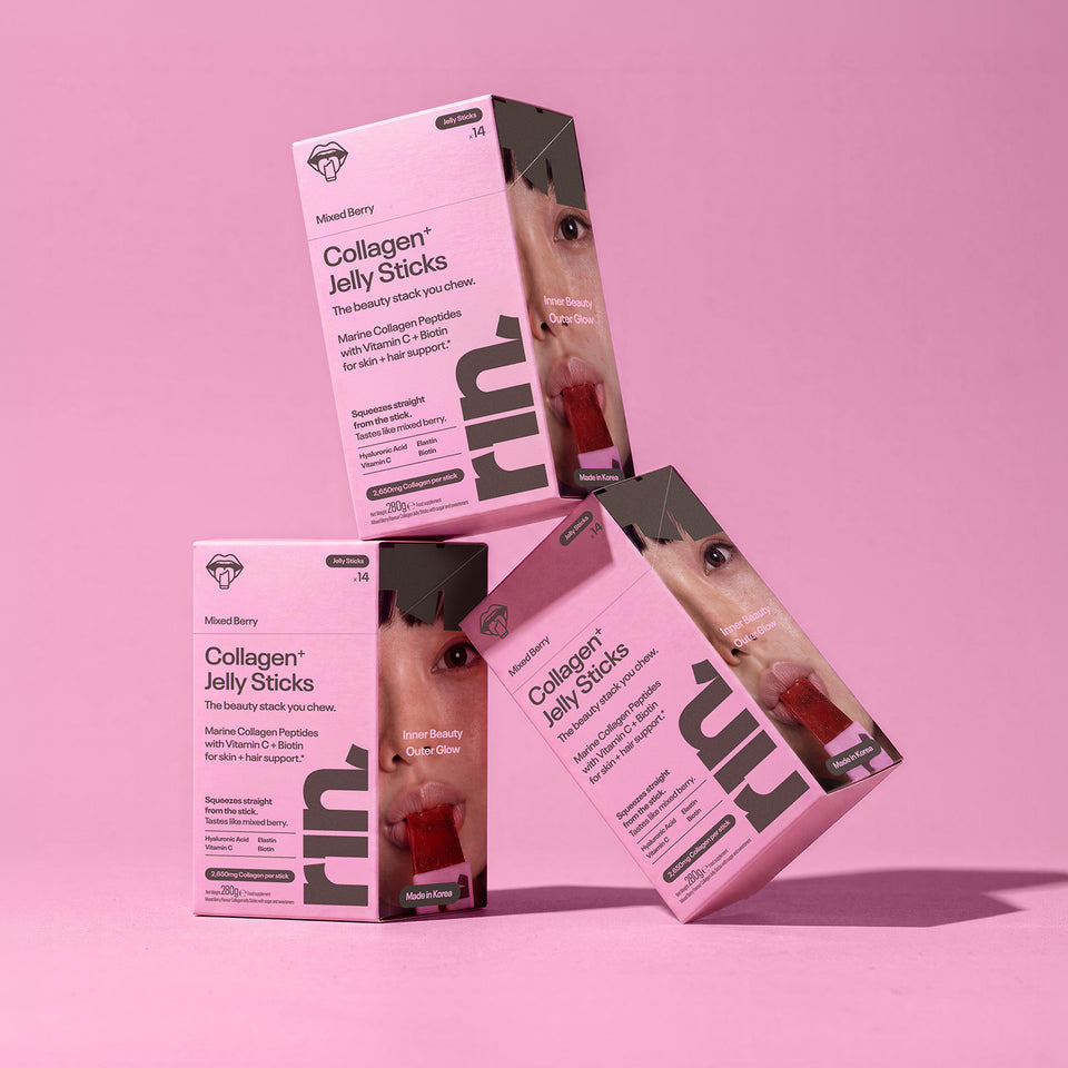 Three boxes of RIN Collagen Jelly Sticks against a solid pink background.