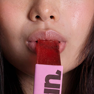 Close-up of a person biting down on a RIN Jelly Collagen Stick